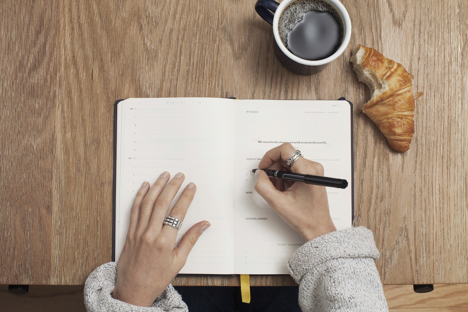 Person handwriting meeting notes on a digital paper tablet.