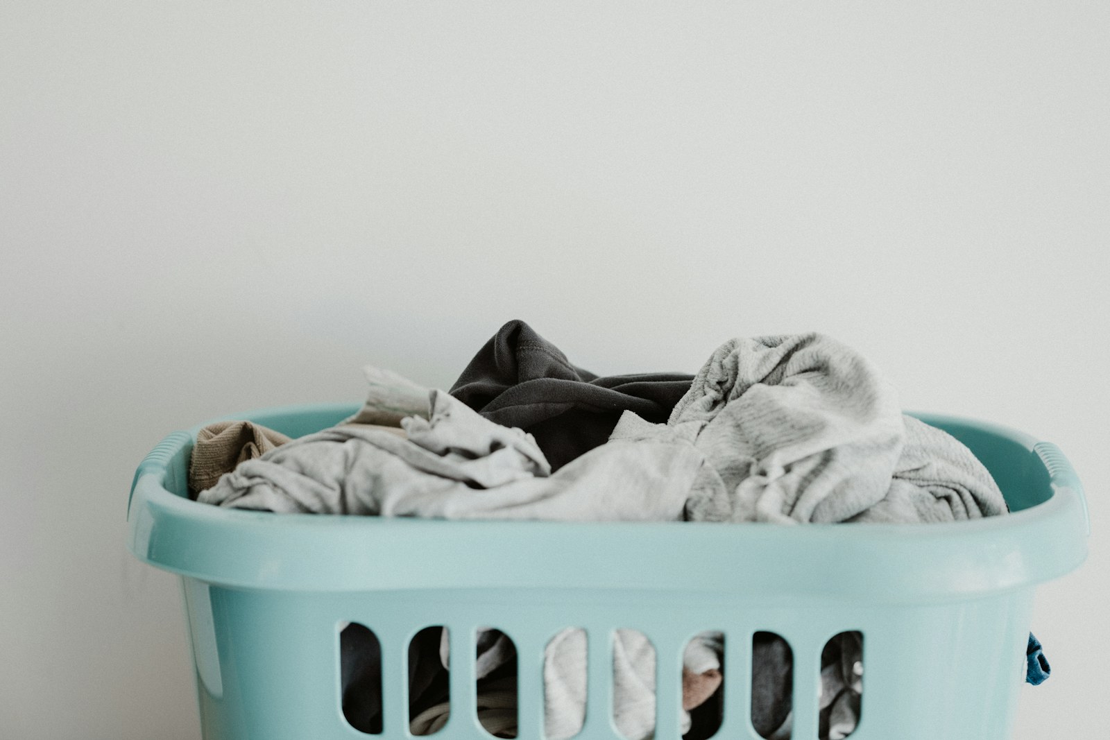 Foldable laundry drying rack in a bright compact utility area.