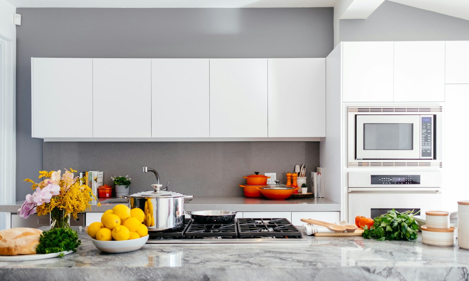 Organized rental kitchen with removable shelves and labeled bins.