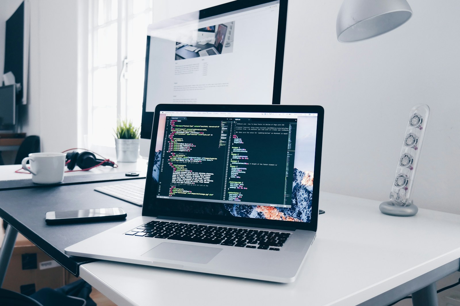 Compact laptop workspace in a bright small apartment living room.