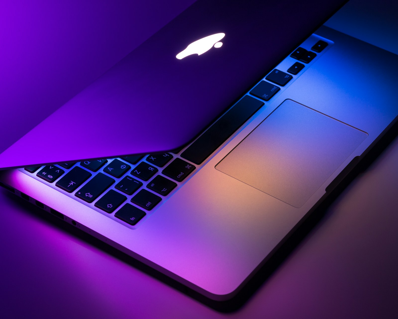 USB-C cables beside a laptop and phone on a real home desk.